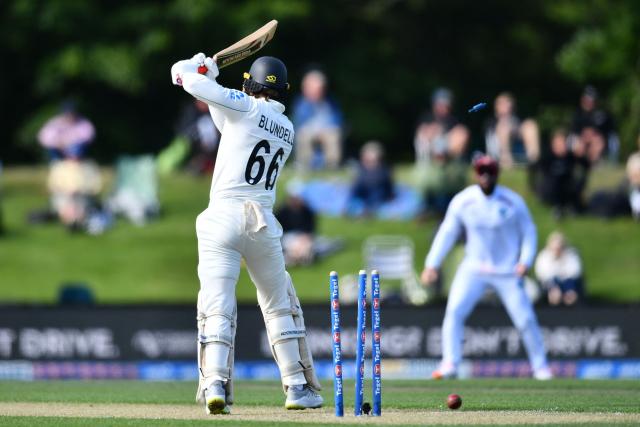 New Zealand's Tom Blundell is bowled by West Indies' Ojay Shields during day one of the first Test cricket match between New Zealand and West Indies at Hagley Oval in Christchurch on December 2, 2025. (Photo by Sanka Vidanagama / AFP)