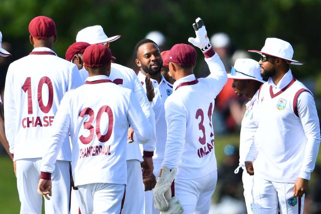 West Indies' Ojay Shields (C) celebrates the wicket of New Zealand's Tom Blundell with his teammates during day one of the first Test cricket match between New Zealand and West Indies at Hagley Oval in Christchurch on December 2, 2025. (Photo by Sanka Vidanagama / AFP)