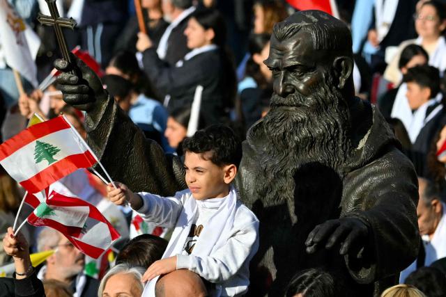 People gather outside the Sisters of the Cross Hospital in Beirut's northern suburb of Jdeideh before the visit of Pope Leo XIV on December 2, 2025.  (Photo by Andreas SOLARO / AFP)