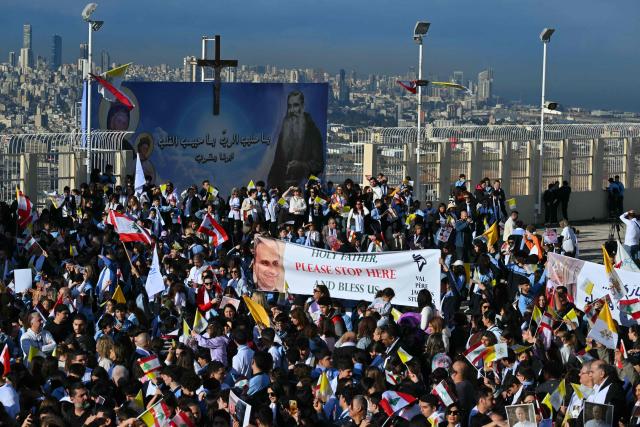 People gather outside the Sisters of the Cross Hospital in Beirut's northern suburb of Jdeideh before the visit of Pope Leo XIV on December 2, 2025.  (Photo by Andreas SOLARO / AFP)