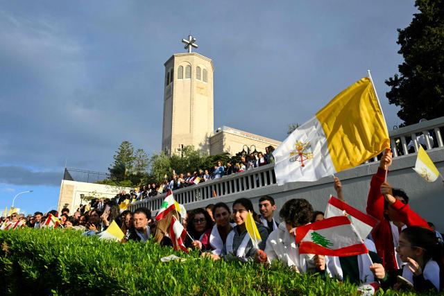 People gather outside the Sisters of the Cross Hospital in Beirut's northern suburb of Jdeideh before the visit of Pope Leo XIV on December 2, 2025.  (Photo by Andreas SOLARO / AFP)