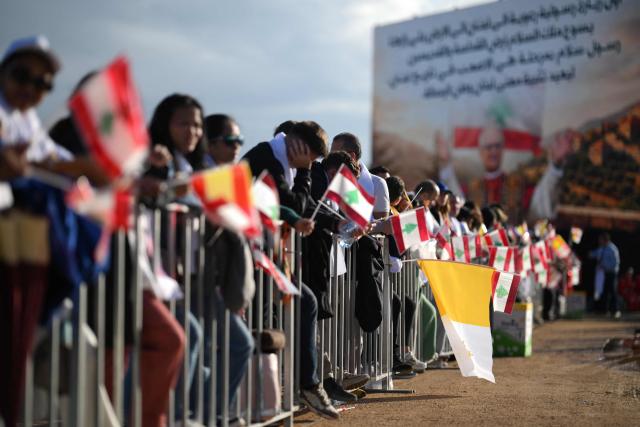 People wait for the arrival of Pope Leo XIV to conduct a mass in Beirut, on December 2, 2025. The pontiff arrived from Turkey on November 30, on his inaugural visit abroad as Pope and brought a message of hope, particularly to young people in Lebanon, whose faith in their beleaguered country has dwindled. (Photo by Jewel SAMAD / AFP)