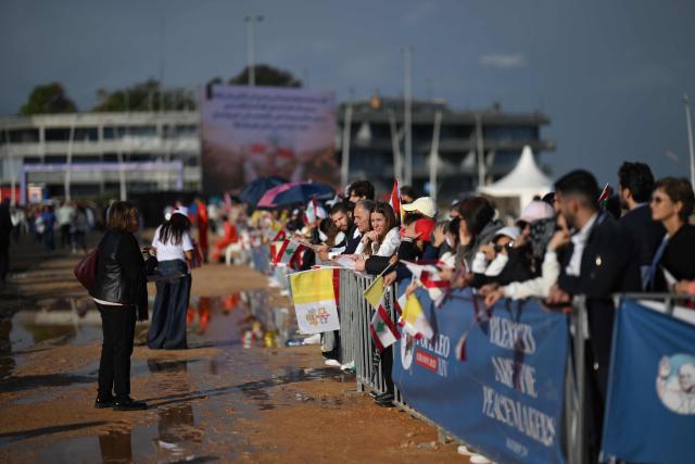 People wait for the arrival of Pope Leo XIV to conduct a mass in Beirut, on December 2, 2025. The pontiff arrived from Turkey on November 30, on his inaugural visit abroad as Pope and brought a message of hope, particularly to young people in Lebanon, whose faith in their beleaguered country has dwindled. (Photo by Jewel SAMAD / AFP)