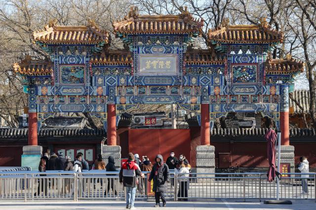 People visit the Lama Temple in Beijing on December 2, 2025. (Photo by Ludovic MARIN / AFP)