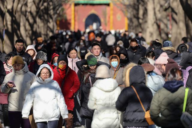 People visit the Lama Temple in Beijing on December 2, 2025. (Photo by Ludovic MARIN / AFP)