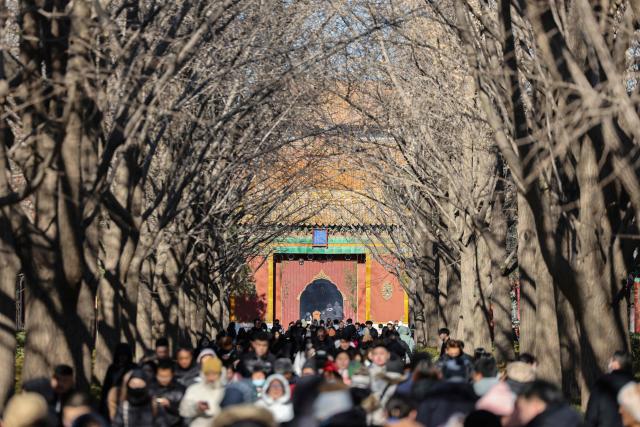 People visit the Lama Temple in Beijing on December 2, 2025. (Photo by Ludovic MARIN / AFP)