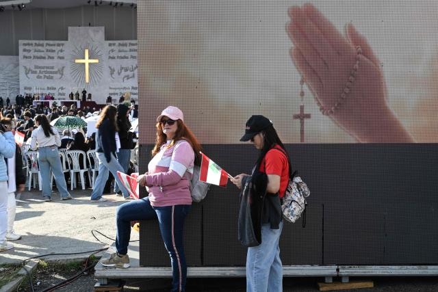 Faithfuls wait for the mass led by Pope Leo XIV to begin at Beirut's waterfront on December 2, 2025. Thousands of Lebanese faithful were making their way to Beirut's waterfront ahead of Pope Leo XIV's mass in the morning of December 2, the highlight of the Catholic leader's visit to the capital expected to draw huge crowds. (Photo by Jewel SAMAD / AFP)