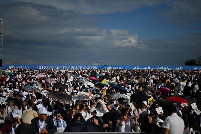 Faithfuls attend while Pope Leo XIV delivers the homily during a mass at Beirut's waterfront on December 2, 2025. The pontiff arrived from Turkey on November 30, on his inaugural visit abroad as Pope and brought a message of hope, particularly to young people in Lebanon, whose faith in their beleaguered country has dwindled. (Photo by Jewel SAMAD / AFP)