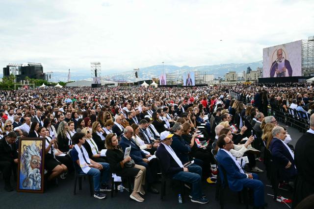 Lebanese faithful attend a mass led by Pope Leo XIV at Beirut's waterfront on December 2, 2025. Thousands of Lebanese faithful were making their way to Beirut's waterfront ahead of Pope Leo XIV's mass in the morning of December 2, the highlight of the Catholic leader's visit to the capital expected to draw huge crowds. (Photo by Giuseppe CACACE / AFP)