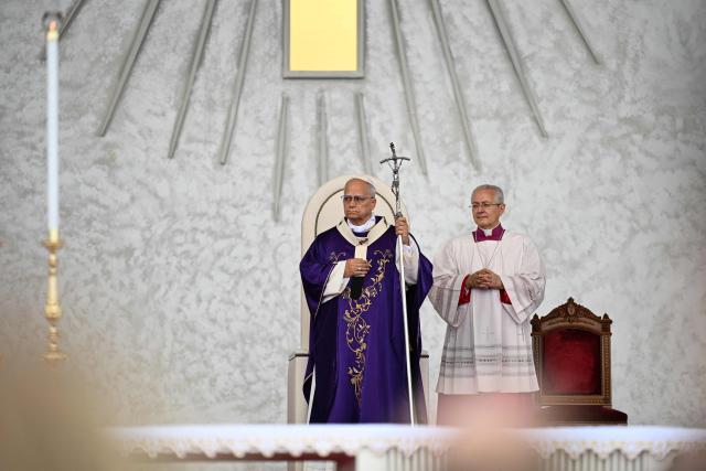 Pope Leo XIV (L) leads a mass at Beirut's waterfront on December 2, 2025. Thousands of Lebanese faithful were making their way to Beirut's waterfront ahead of Pope Leo XIV's mass in the morning of December 2, the highlight of the Catholic leader's visit to the capital expected to draw huge crowds. (Photo by Jewel SAMAD / AFP)
