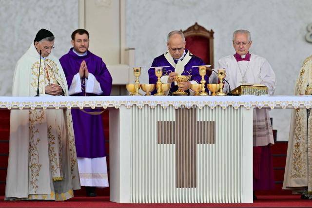 Pope Leo XIV (C) leads a mass at Beirut's waterfront on December 2, 2025. Tens of thousands of people gathered at Beirut's waterfront as Pope Leo XIV held mass in the morning of December 2, the highlight of the Catholic leader's visit to the capital. (Photo by Giuseppe CACACE / AFP)