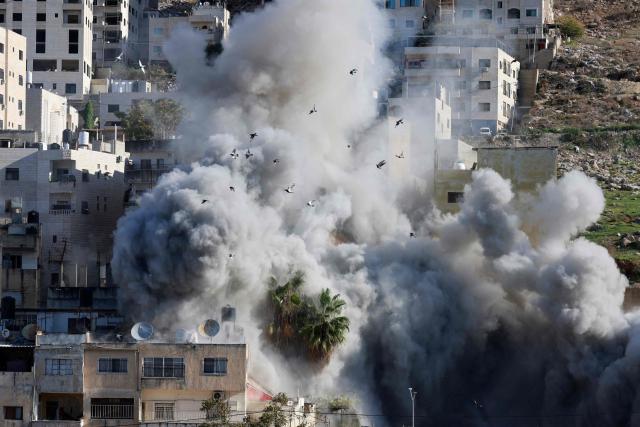 Smoke billows as Israeli forces demolish the house of Abdul Karim Snobar, who was detained by Israel earlier this year after being accused of plotting bus bombings, in the occupied West Bank city of Nablus on December 2, 2025. (Photo by Jaafar ASHTIYEH / AFP)