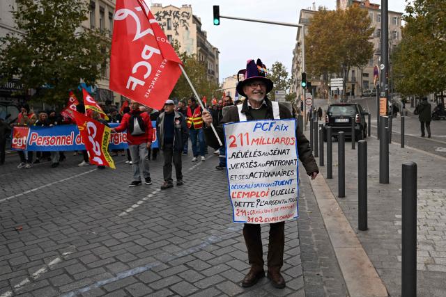 People participate in a demonstration as part of a call by trade unions for strikes and demonstrations for higher wages and against austerity, in Marseille, southern France, on December 2, 2025. (Photo by Miguel MEDINA / AFP)