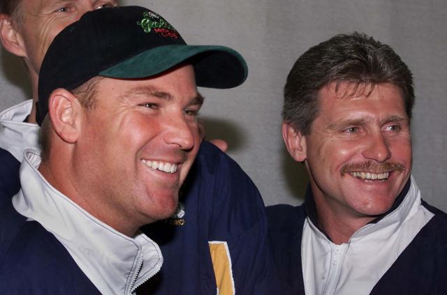 (FILES) Australia's Shane Warne (L) and team captain Robin Smith (R) pose at the Hampshire County Ground as Warne made his debut against Essex in the English County Championship in Southampton on April 18, 2000. Former England batter Robin Smith has died at the age of 62, English county side Hampshire announced on December 2, 2025. Smith, who played 62 Tests between 1988 and 1996, died unexpectedly on December 1 in Australia, where he lived, his family said. (Photo by Adrian DENNIS / AFP)