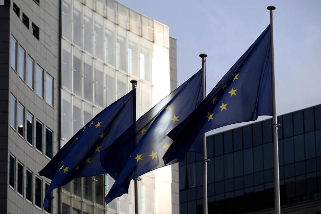 This photograph shows European flags fluttering in the European district in Brussels on December 2, 2025. (Photo by Nicolas TUCAT / AFP)