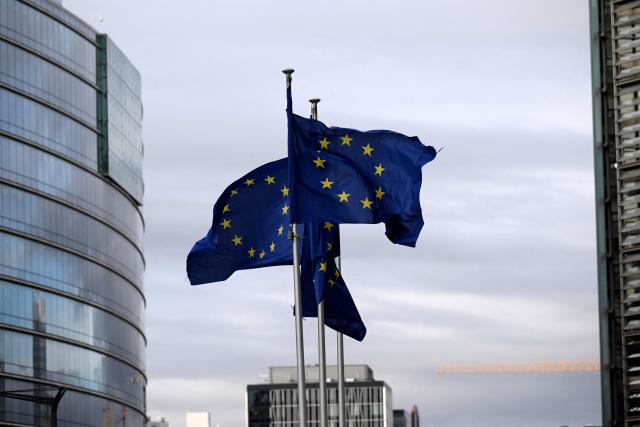 This photograph shows European flags fluttering in the European district in Brussels on December 2, 2025. (Photo by Nicolas TUCAT / AFP)