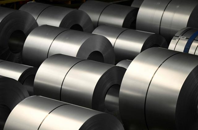 (FILES) Steel coils are seen at the steel works of Thyssenkrupp Steel Europe AG in Duisburg, western Germany, on October 22, 2025. Germany's economy is suffering its "deepest crisis" since World War II, an industry group warned on December 2, 2025, calling on Chancellor Friedrich Merz's government to take urgent action to spark a revival. Europe's biggest economy "is in free fall, but the federal government is not responding decisively enough," said Peter Leibinger, president of the Federation of German Industries (BDI). (Photo by Ina FASSBENDER / AFP)