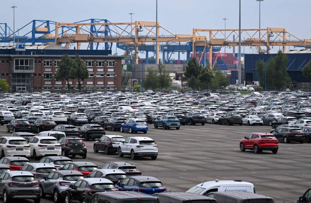 (FILES) Cars stand ready for export at a parking of the Duisburg harbour, western Germany, on July 14, 2025. Germany's economy is suffering its "deepest crisis" since World War II, an industry group warned on December 2, 2025, calling on Chancellor Friedrich Merz's government to take urgent action to spark a revival. Europe's biggest economy "is in free fall, but the federal government is not responding decisively enough," said Peter Leibinger, president of the Federation of German Industries (BDI). (Photo by Ina FASSBENDER / AFP)