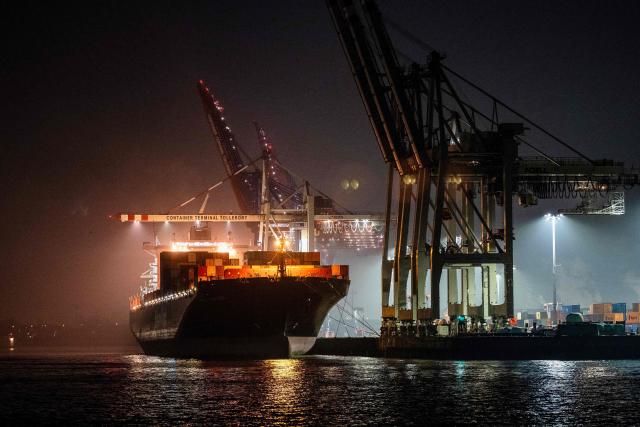 (FILES) A container ship is moored at a terminal of Europe's second largest container port in Hamburg, northern Germany on February 3, 2025. Germany's economy is suffering its "deepest crisis" since World War II, an industry group warned on December 2, 2025, calling on Chancellor Friedrich Merz's government to take urgent action to spark a revival. Europe's biggest economy "is in free fall, but the federal government is not responding decisively enough," said Peter Leibinger, president of the Federation of German Industries (BDI). (Photo by Ina FASSBENDER / AFP)