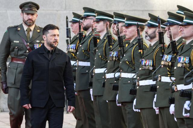 Ukraine's President Volodymyr Zelensky (front L) inspects a guard of honour on arrival at the government buildings on his first official visit in Dublin on December 2, 2025. (Photo by Paul Faith / AFP)
