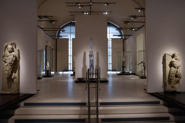 Ethnic statues are diplayed in the "Galerie des Cinq Continents" (The Five Continents Gallery) in the "Aile Denon" (Denon wing) of the Louvre museum, ahead of its reopening to the public, in Paris, on December 2, 2025. (Photo by Ian LANGSDON / AFP)