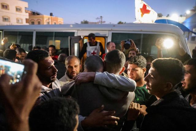 TOPSHOT - A family member embraces a Palestinian man who was released from Israeli prisons under as a Gaza ceasefire and hostage exchange deal as he arrives in Khan Yunis, in the southern Gaza Strip on December 2, 2025. The ceasefire which came into effect on October 10 remains fragile, with Israel and Hamas accusing each other of violating the terms, while the Gaza Strip remains in a deep humanitarian crisis. (Photo by Bashar Taleb / AFP)