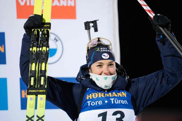 France's Camille Bened celebrates on the podium after winning third place at the women's 15km individual event of the IBU Biathlon World Cup in Oestersund, Sweden on December 2, 2025. (Photo by Bjorn LARSSON ROSVALL / TT NEWS AGENCY / AFP) / Sweden OUT