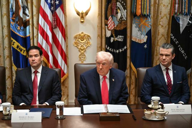 US President Donald Trump (C), alongside Secretary of State Marco Rubio (L) and Secretary of Defense Pete Hegseth (R), holds a Cabinet Meeting in the Cabinet Room of the White House in Washington, DC on December 2, 2025. (Photo by ANDREW CABALLERO-REYNOLDS / AFP)