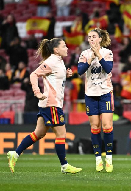 Spain's forward #20 Claudia Pina and Spain's midfielder #11 Alexia Putellas (R) warm up prior the UEFA Women's Nations League second leg final football match between Spain and Germany at the Metropolitano Stadium in Madrid on December 2, 2025. (Photo by Javier SORIANO / AFP)