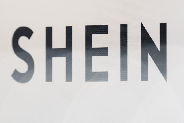 (FILES) This photograph shows the logo of Asian e-commerce giant Shein in its stall at the Bazar de l'Hotel de Ville (BHV) department store in Paris on November 4, 2025. Noting Shein's absence from a summons, the chair of the National Assembly's Sustainable Development and Spatial Planning Committee announces on December 2, 2025, she will refer the matter to the public prosecutor. (Photo by Julie SEBADELHA / AFP)