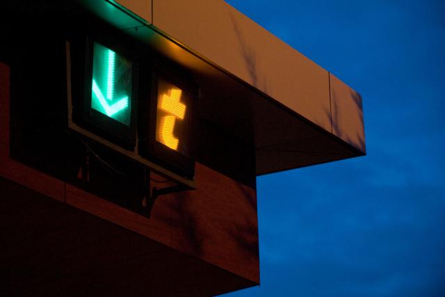 (FILES) A picture shows signs indicating an open booth and electronic toll payment at the toll gate on the A89 motorway on February 2, 2015 in Thiers, central France, during a demonstration to demand the renationalization of this portion of the motorway between Clermont-Ferrand and Lyon, and for its use to be free of charge. Motorway tolls will increase their prices by an average of 0.86% from February 1, 2026, less than the inflation expected for next year, France's Transport Ministry announces on December 2, 2025. (Photo by THIERRY ZOCCOLAN / AFP)