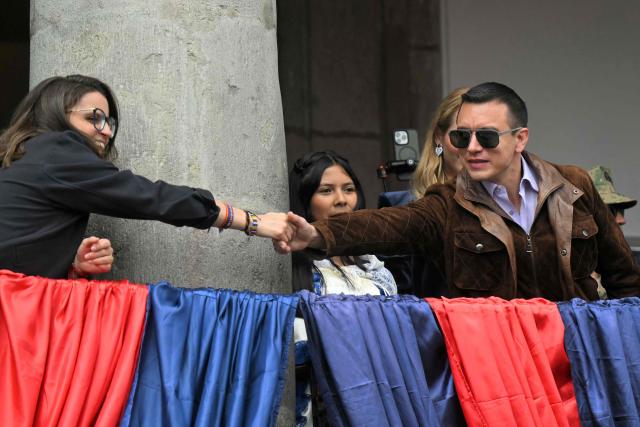 Ecuador's President Daniel Noboa (R) shakes hands with vice-president Maria Jose Pinto at the Carondelet Palace during a traditional serenade in Quito on December 2, 2025, on the Ecuadorian capital's founding anniversary. (Photo by Rodrigo BUENDIA / AFP)