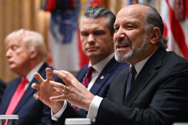 US Secretary of Commerce Howard Lutnick (R) speaks alongside Secretary of Defense Pete Hegseth (C) and President Donald Trump (L) during a Cabinet Meeting in the Cabinet Room of the White House in Washington, DC on December 2, 2025. (Photo by ANDREW CABALLERO-REYNOLDS / AFP)