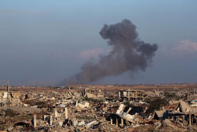 This picture taken from the Nuseirat camp for displaced Palestinians shows destroyed buildings and smoke billowing in the distance following Israeli strikes east of Gaza City on December 2, 2025. A ceasefire which came into effect on October 10 remains fragile, with Israel and Hamas accusing each other of violating the terms, while the Gaza Strip remains in a deep humanitarian crisis. (Photo by Eyad Baba / AFP)