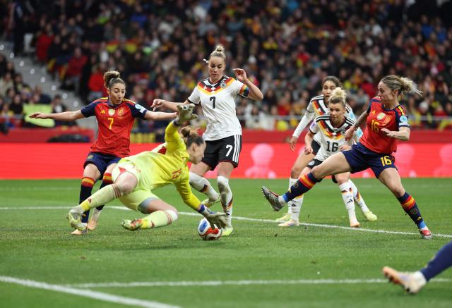 Germany's defender #07 Giulia Gwinn challenges Spain's goalkeeper #13 Cata Coll during the UEFA Women's Nations League second leg final football match between Spain and Germany at the Metropolitano Stadium in Madrid on December 2, 2025. (Photo by Thomas COEX / AFP)