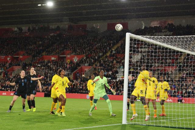 Players gaze at a loose ball during the women's International football friendly match between England and Ghana at St Mary's Stadium in Southampton, southern England on December 2, 2025. (Photo by Adrian DENNIS / AFP)