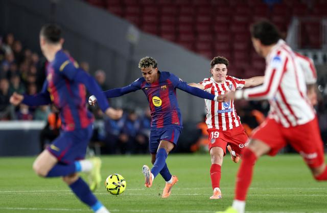Barcelona's Spanish forward #10 Lamine Yamal kicks the ball during the Spanish league football match between FC Barcelona and Club Atletico de Madrid at Camp Nou Stadium in Barcelona on December 2, 2025. (Photo by Josep LAGO / AFP)