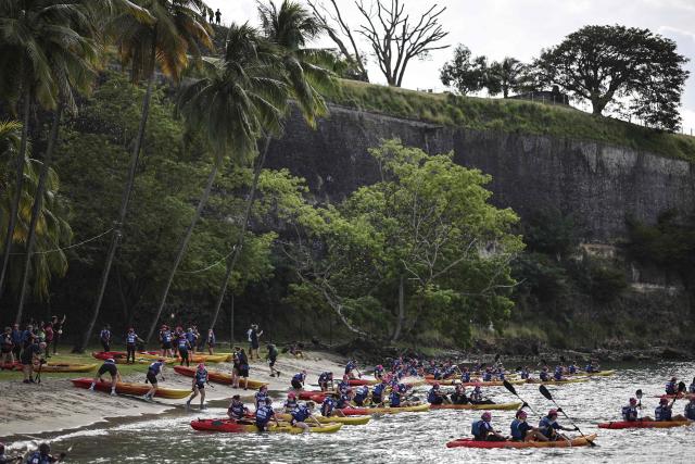 Competitors take part in a kayak race as part of the 'Raid des Alizes', an exclusively all-female multi sport competition, on the French Caribbean island of Martinique, on November 26, 2025. The all-female event features running, mountain biking, kayaking, and trekking events with each team representing a charity project of their choice with the overall ranking determining the prize money which will be directly donated to the charities. (Photo by Anne-Christine POUJOULAT / AFP)