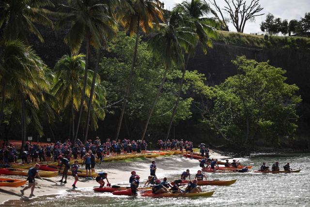 Competitors take part in a kayak race as part of the 'Raid des Alizes', an exclusively all-female multi sport competition, on the French Caribbean island of Martinique, on November 26, 2025. The all-female event features running, mountain biking, kayaking, and trekking events with each team representing a charity project of their choice with the overall ranking determining the prize money which will be directly donated to the charities. (Photo by Anne-Christine POUJOULAT / AFP)