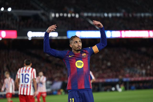 Barcelona's Brazilian forward #11 Raphinha gestures toward the fans during the Spanish league football match between FC Barcelona and Club Atletico de Madrid at Camp Nou Stadium in Barcelona on December 2, 2025. (Photo by Josep LAGO / AFP)
