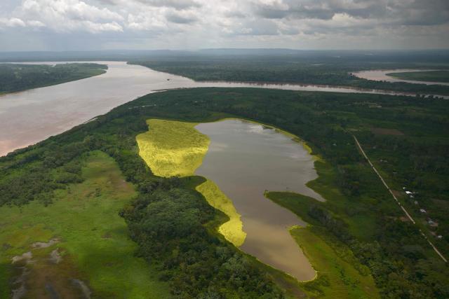 Aerial view of the area of a vessel accident at the port of Iparia, in the Ucayali department in Peru's central jungle, on December 2, 2025. At least 12 people, including three children, died when a landslide buried two boats docked at a river port in central Peru, with dozens of others missing, officials said. (Photo by Hugo Alejos / AFP)