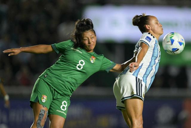 Bolivia's midfielder #08 Ruth Soliz and Argentina's forward #21 Paulina Gramaglia fight for the ball during the Conmebol Women's Nations League 2025-26 football match between Argentina and Bolivia at the Florencio Sola Stadium in Banfield, Buenos Aires province on December 2, 2025. (Photo by JUAN MABROMATA / AFP)