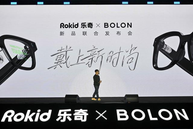 This picture taken on November 13, 2025 shows Misa Zhu, CEO and founder of Rokid, speaking during a presentation event for the new Rokid glasses in collaboration with Bolon in Hangzhou, in China's eastern Zhejiang province. In China, AI glasses let the wearer pay in shops with just a glance at a QR code and a voice command, as a growing number of companies look to conquer both growing domestic and overseas markets. Interest in smart eyewear is soaring worldwide after more than a decade of stalled promise, with advances in artificial intelligence sparking renewed interest in the sector. (Photo by Hector RETAMAL / AFP) / To go with 'CHINA-TECHNOLOGY-WEARABLES-AI, FOCUS' by Emily WANG