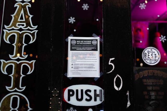A "No ICE access" sign is taped on the door of a business in New Orleans, Louisiana, on December 2, 2025. According to US media reports, US Immigration and Customs Enforcement (ICE) and US Customs and Border Patrol are expected to begin a large-scale immigration enforcement operation known as "Swamp Sweep" in Southern Louisiana and Mississippi. (Photo by Adam GRAY / AFP)
