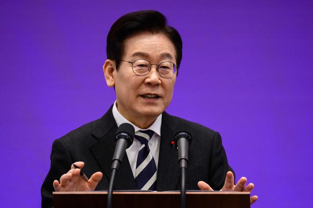 South Korea President Lee Jae Myung gestures as he holds a press conference at the Blue House in Seoul on December 3, 2025, on the first anniversary of the declaration of martial law by ousted president Yoon Suk Yeol. (Photo by ANTHONY WALLACE / AFP)