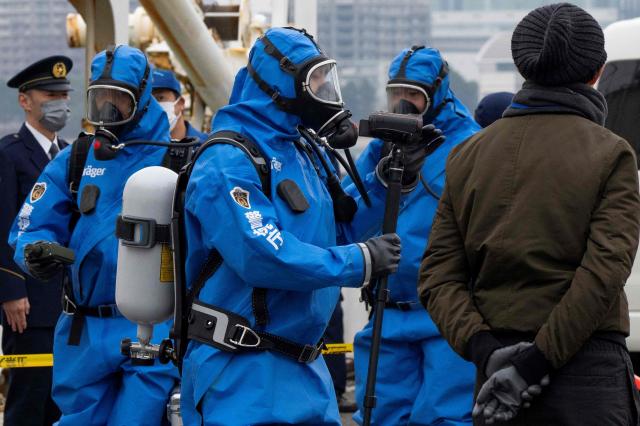 Police officers in protective gear discover a suspicious substance in the cargo during the PSI (Proliferation Security Initiative) maritime interdiction exercise Pacific "Shield 25" as part of the training at a port in Tokyo on December 3, 2025. (Photo by Kazuhiro NOGI / AFP)