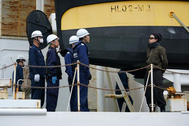 Officials from the Japan Coast Guard, customs, and police question the captain of the suspicious ship about its cargo during the PSI (Proliferation Security Initiative) maritime interdiction exercise Pacific "Shield 25" as part of the training at a port in Tokyo on December 3, 2025. (Photo by Kazuhiro NOGI / AFP)