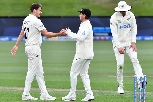 New Zealand's Jacob Duffy (L) celebrates the wicket of West Indies' Ojay Shields with his teammates during day two of the first Test cricket match between New Zealand and West Indies at Hagley Oval in Christchurch on December 3, 2025. (Photo by Sanka Vidanagama / AFP)