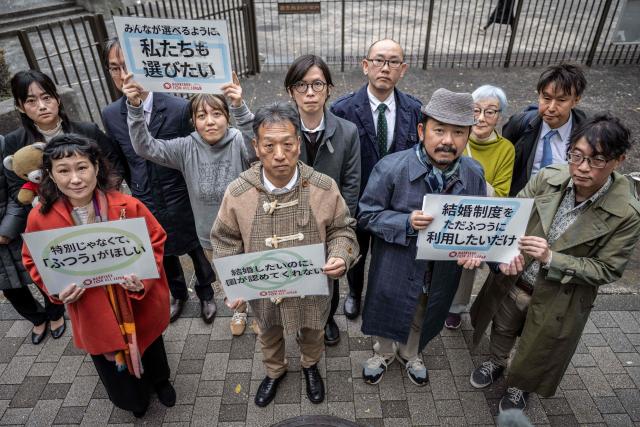 Campaigners working for the legalisation of same-sex marriage in Japan, pose outside the Supreme Court in Tokyo on December 3, 2025. (Photo by Yuichi YAMAZAKI / AFP)