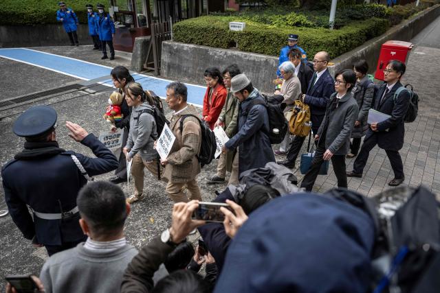 Campaigners working for the legalisation of same-sex marriage in Japan, walk into the Supreme Court in Tokyo on December 3, 2025. (Photo by Yuichi YAMAZAKI / AFP)